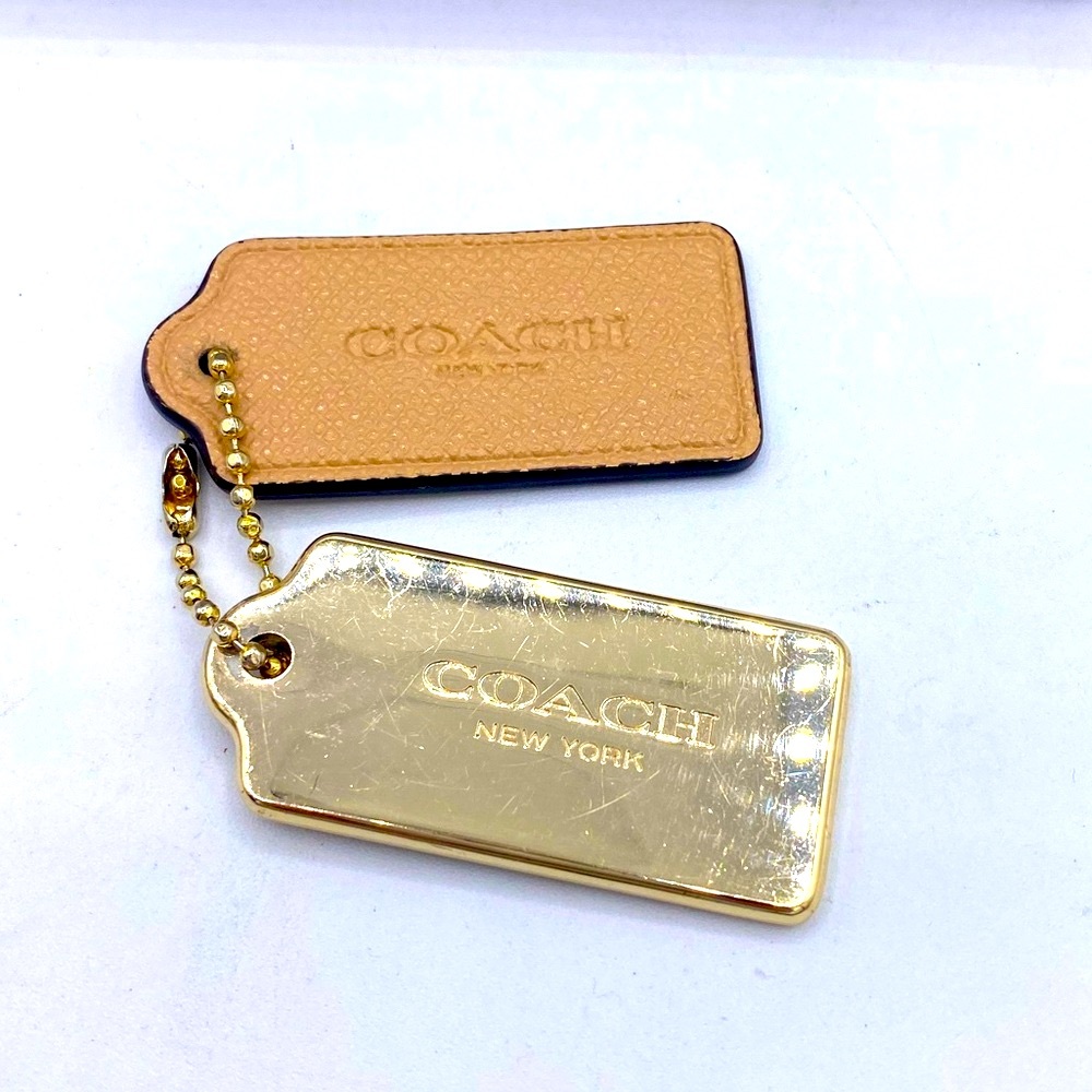 Coach Two Keychains A Gold One And Tan One Coach New York Is On The Front